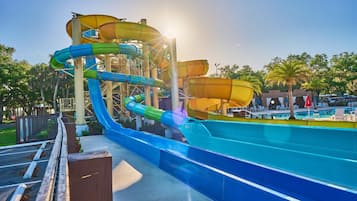 A water park with multiple water slides and a pool area.