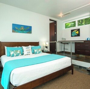A bedroom with a bed, a desk, and a view of greenery through a window. - NEW! Dreamy & Spacious 5-bedroom house with generator in Cruz Bay with Pool (Cruz Bay)