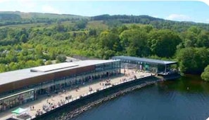 A riverside building with a covered walkway and a viewing area.