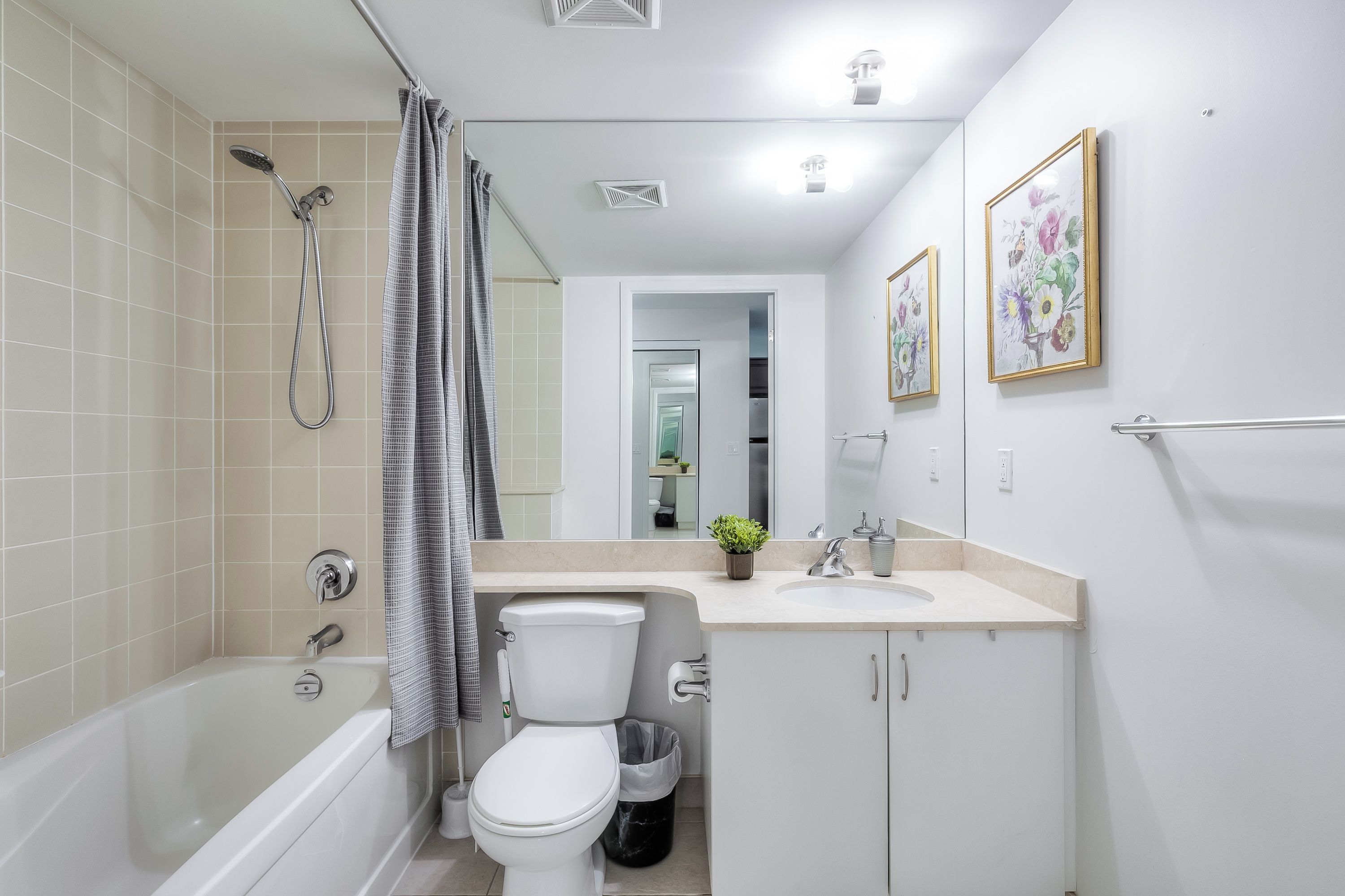 A modern bathroom with a bathtub, toilet, and sink.