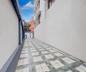 Un callejón estrecho con suelo de baldosas y edificios a ambos lados.