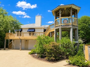 A two-story house with a wooden deck, a covered porch, and a garage. - Hidden Treasure -3 BR Home with Private Pool & Hot Tub (Southern Shores)