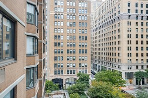 A multi-story building with a brick facade, large windows, and a visible storefront at the ground level. - Blueground | Kips Bay, pool, nr Madison Square Park (New York)