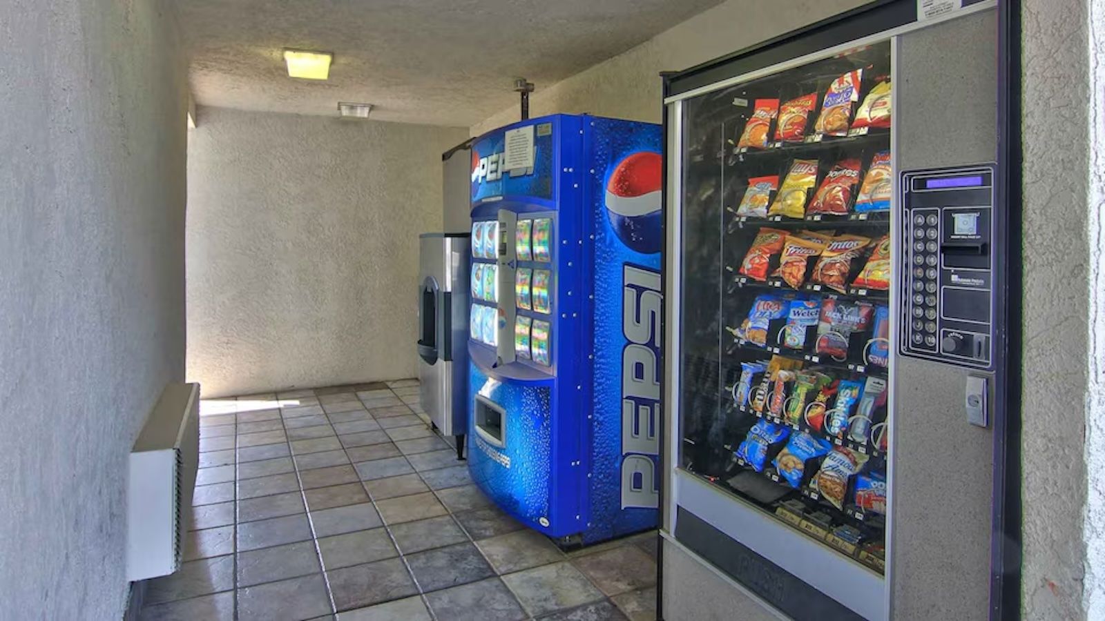 A vending machine area with a Pepsi machine and a snack vending machine.