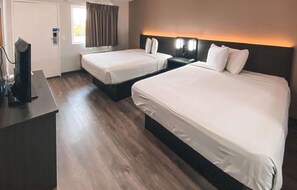 A hotel room with two beds, a desk, a TV, and a window with curtains. - 3 Budget-Friendly Rooms | 3.5 Miles Away from Zoo | Pets Allowed (West Sacramento)