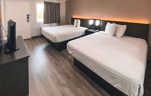 A hotel room with two beds, a desk, a TV, and a window with curtains. - 4 Rooms for Big Groups & Families | 3.1 Mi from California State Capitol Museum (West Sacramento)