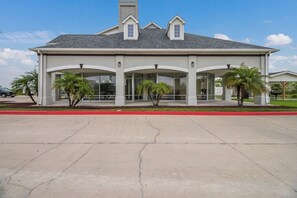 A building with a flat roof, two dormer windows, and a covered entrance with glass doors. - 2 Rooms w/ Kitchen, Free Parking + Pool Access (Ingleside)