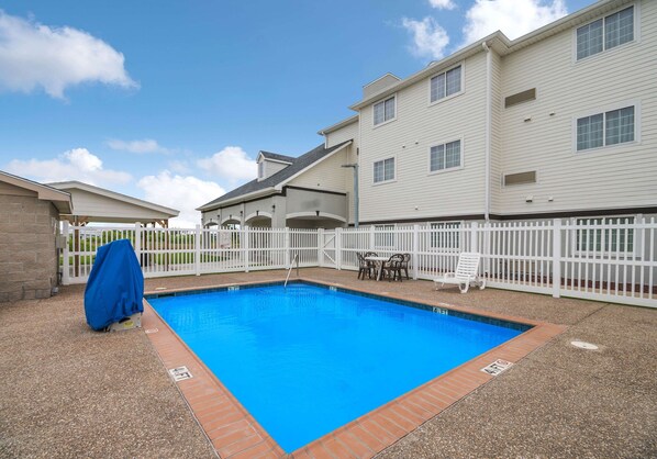 A rectangular swimming pool with a white fence and a covered chair. - 3 Pet-Friendly Ingleside Rooms w/ Kitchen, Free Parking | Onsite Pool Access (Ingleside)