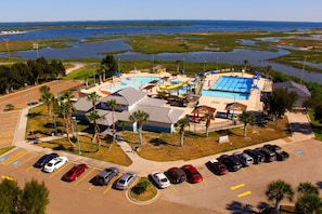 An aerial view of a resort with a swimming pool, water slides, and a parking lot. - 4 Budget-Friendly Rooms for Ingleside Stay! Kitchen, Free Parking, Onsite Pool (Ingleside)