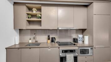 A modern kitchen with a built-in stove, microwave, and oven.
