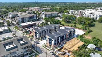 A residential area with multi-story apartment buildings, a parking lot, and a construction site.