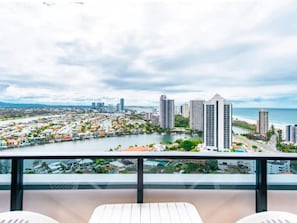 A balcony with a view of a coastal cityscape, including high-rise buildings and a marina. - Dreamy Sands 1 Bedroom Coastal Escape (Surfers Paradise)