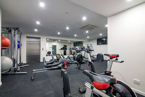 A gym with cardio equipment, weight machines, and exercise balls. - Dreamy Sands 1 Bedroom Coastal Escape (Surfers Paradise)
