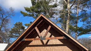 A log cabin with a gabled roof, a front door, and a small porch. - Cozy 2-bedroom cabin in adorable Tomahawk with AC (Tomahawk)