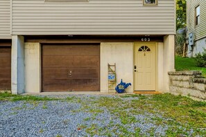 A two-story house with a garage door and a front door.
