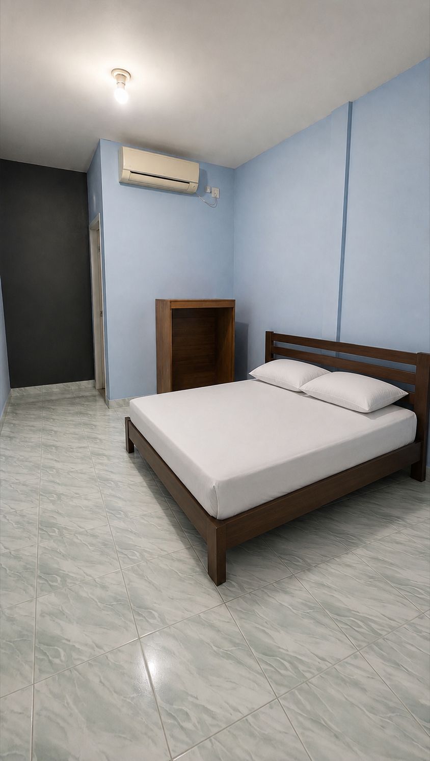 A bedroom with a bed, an air conditioning unit, a nightstand, and a door.