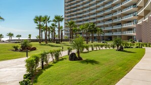 A modern hotel with a multi-story structure, a well-maintained lawn, and palm trees. - Sonoran Star Beachfront 2BR - Ocean & Pool Views · Jacuzzi · Beach Access (Puerto Peñasco)