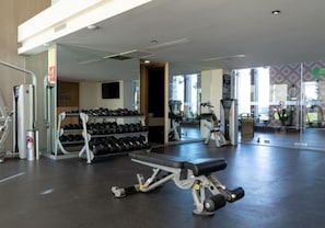 A gym with exercise equipment, dumbbells, and a mirror. - Sonoran Star Beachfront 2BR - Ocean & Pool Views · Jacuzzi · Beach Access (Puerto Peñasco)