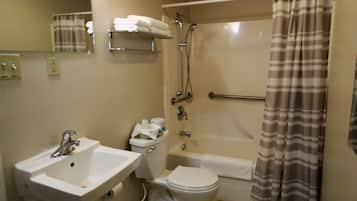 A bathroom with a sink, toilet, and bathtub.
