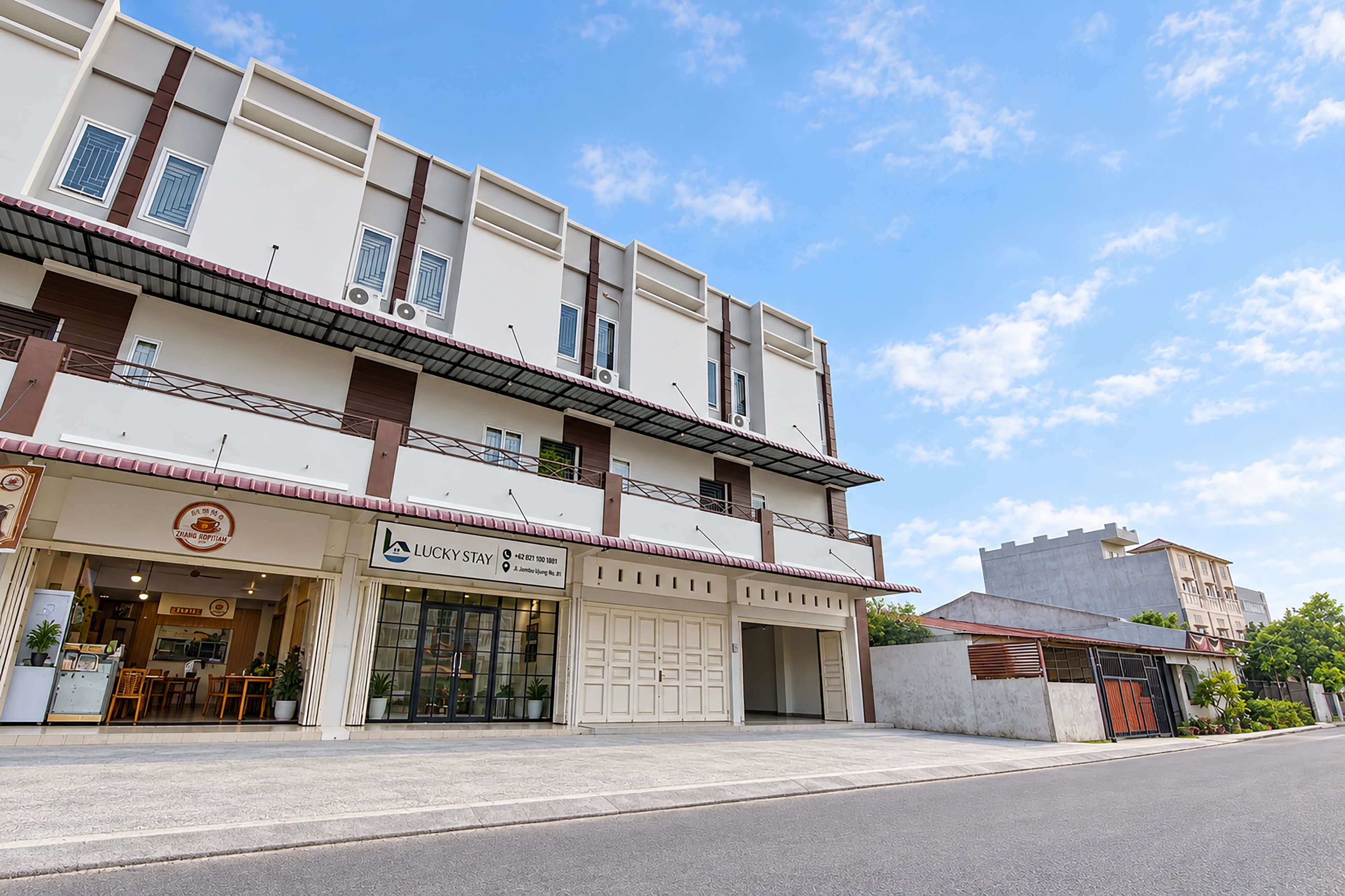 A two-story building with a ground-floor restaurant and a garage.