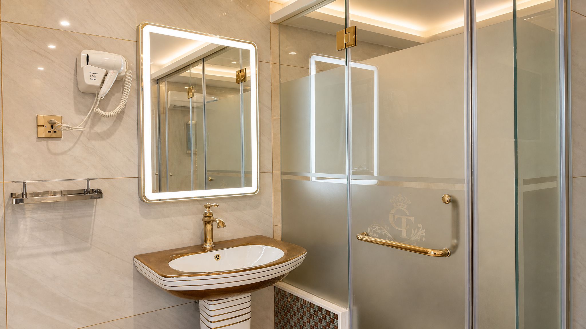 A modern bathroom with a vanity, a mirror, a hairdryer, and a glass shower enclosure.
