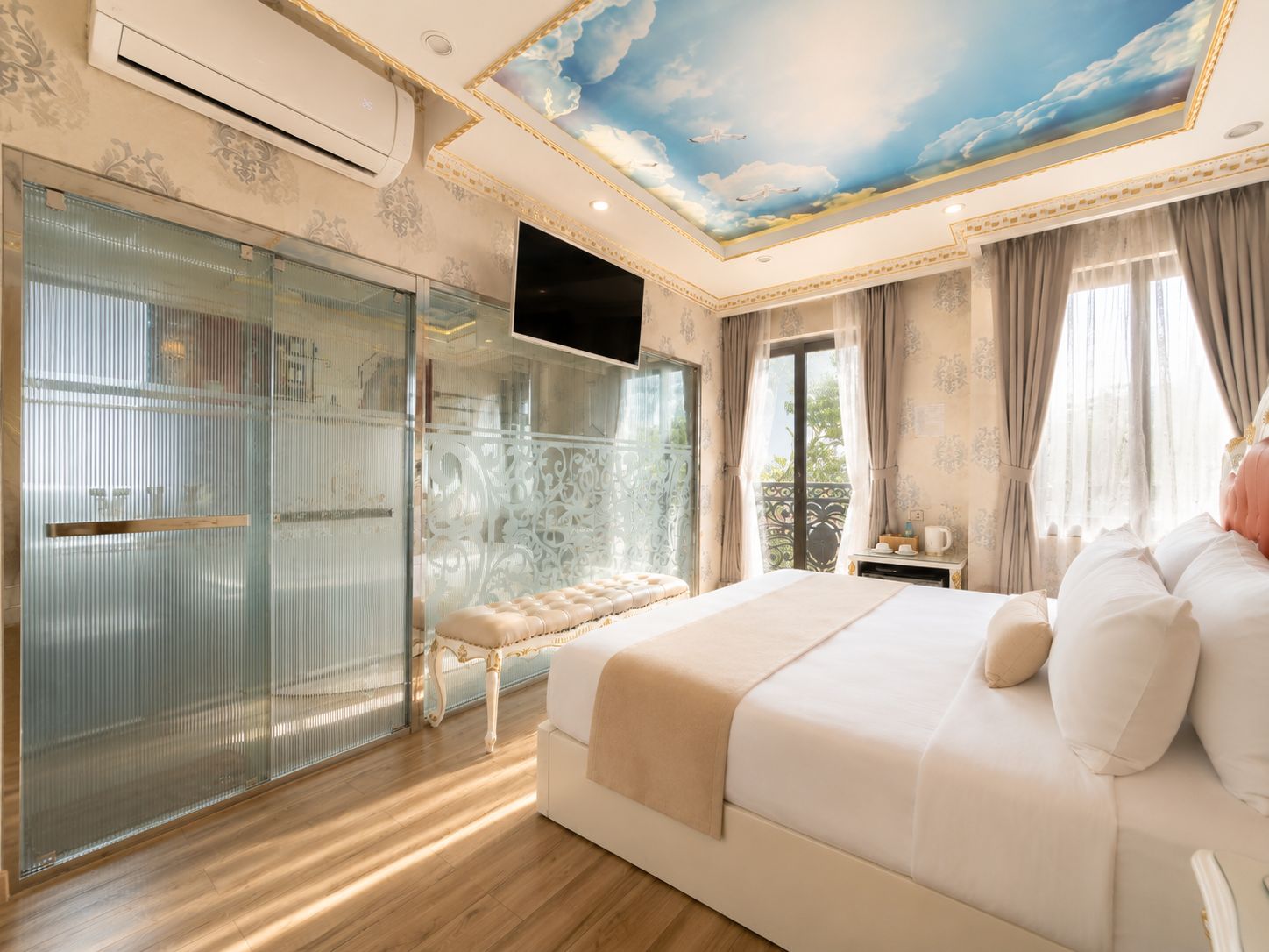 A bedroom with a large bed, a glass-enclosed shower, and a ceiling mural.