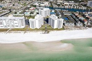 A coastal residential area with high-rise buildings, a beach, and a marina. - Ocean Front w/Direct Pvt Access, Free Beach Setup! New Owner, Pre-Reno Special! (Destin)