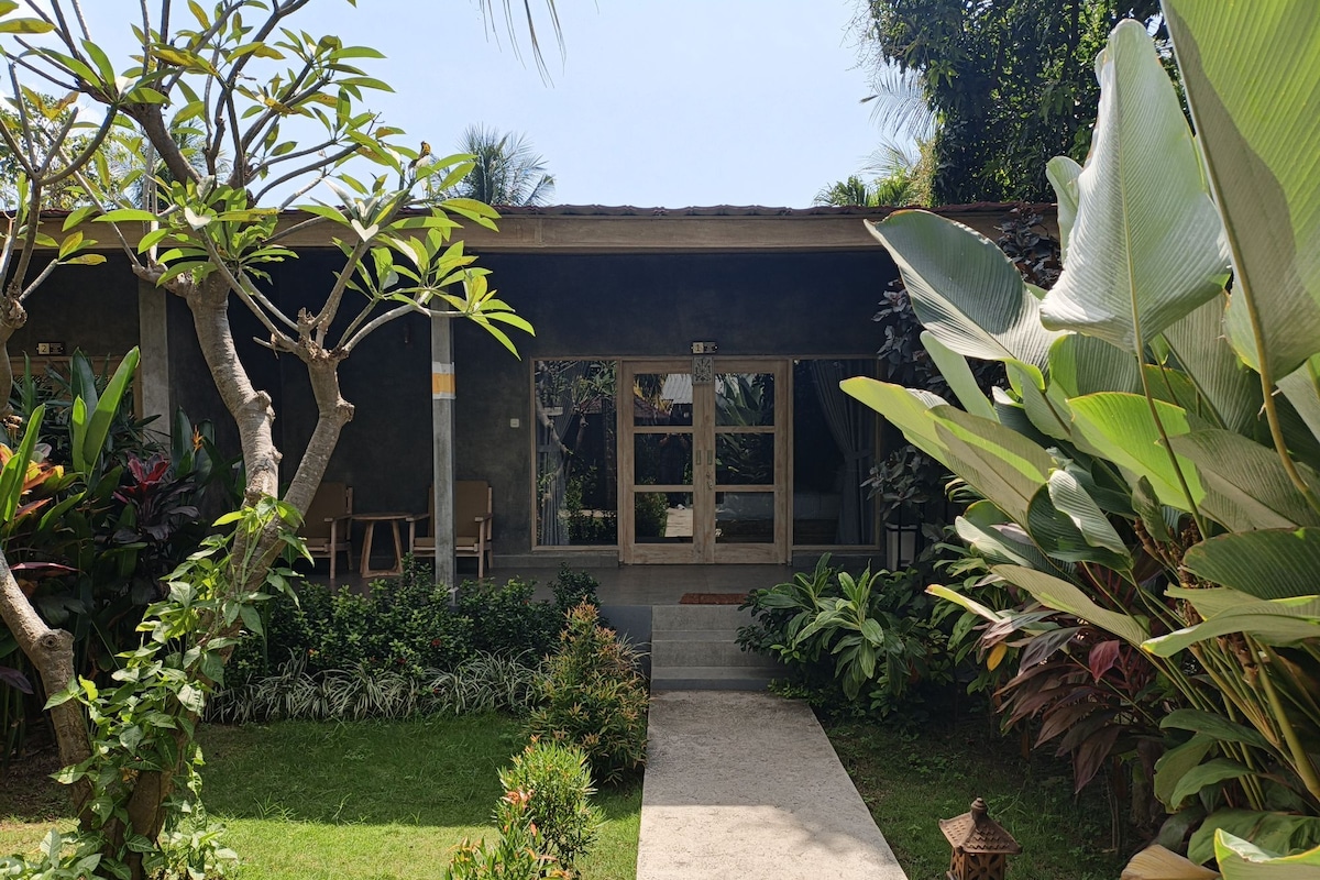 A modern building with a concrete pathway leading to a glass door entrance.