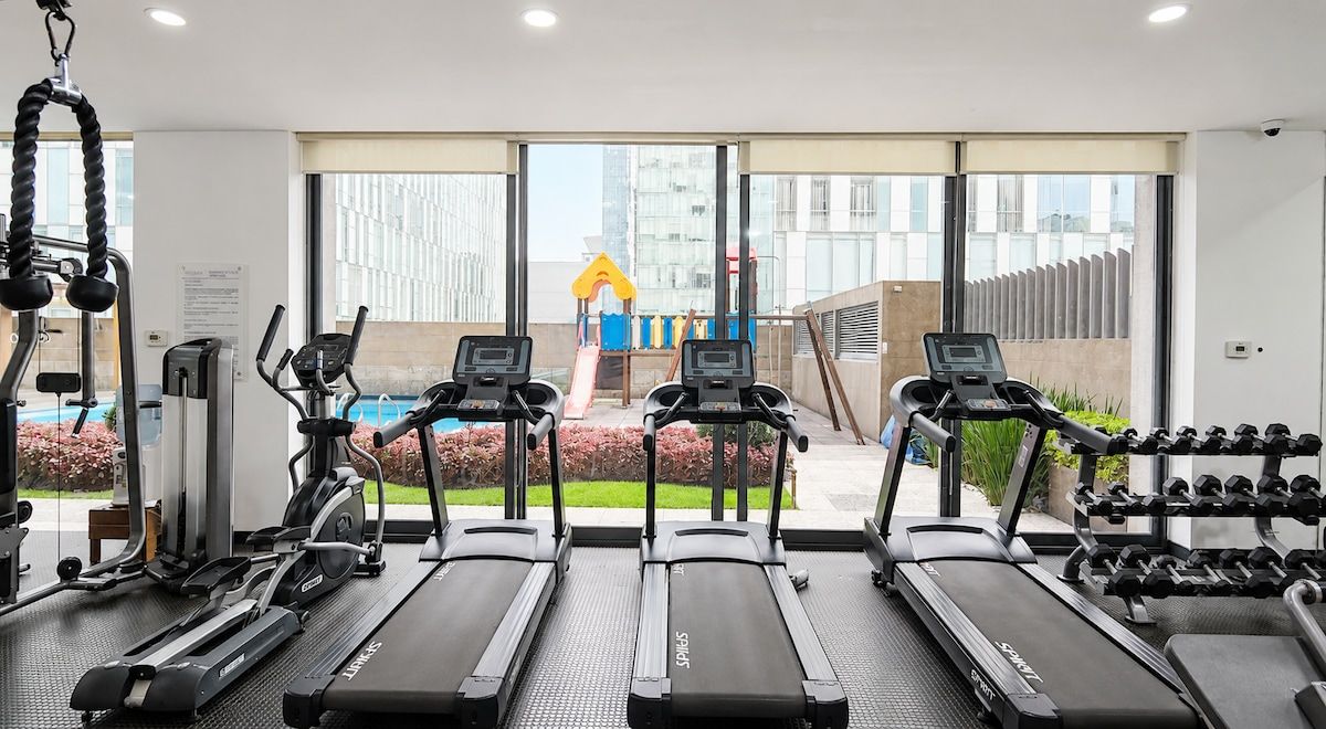 A gym with treadmills, a stationary bike, and weight machines.