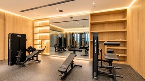 A modern gym with mirrored walls, exercise equipment, and wooden shelving. - 24th-Floor Condo: City View, Pool, Heart of CDMX (Mexico City)