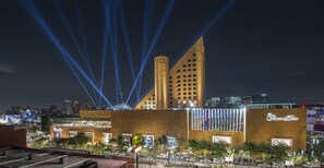 A hotel with a modern design, featuring a prominent tower and a facade with illuminated signage. - Polanco 20th-Floor Condo: Pool, Gym, City Views (Mexico City)