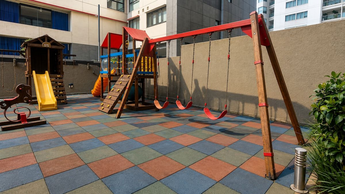 A children's play area with a slide, swings, and a climbing structure.