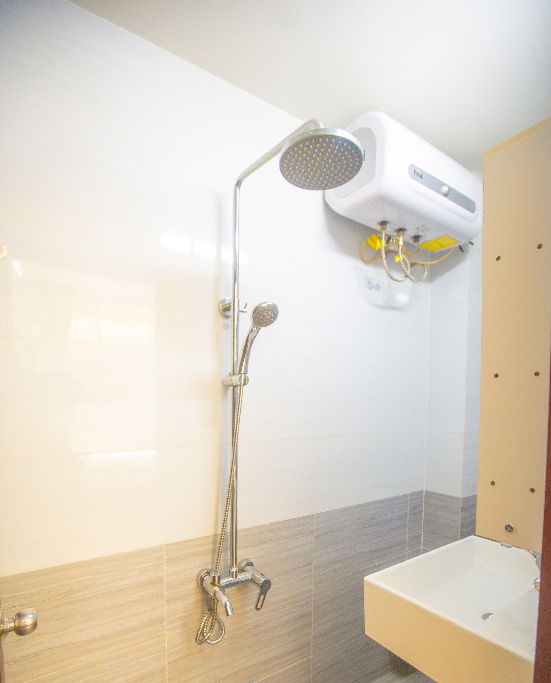 A bathroom with a shower, a sink, and a toilet.