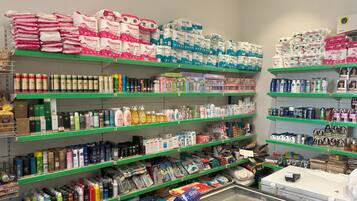 A pharmacy aisle with shelves stocked with various health and beauty products.