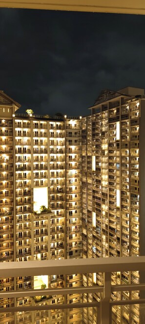 A high-rise building with multiple balconies and windows, likely a hotel or apartment complex. - Spacious Family-Friendly 2BR Near BGC & McKinley! (Pasig)