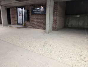 A building entrance with a sign for North Farm Rise Apartments 1-9.