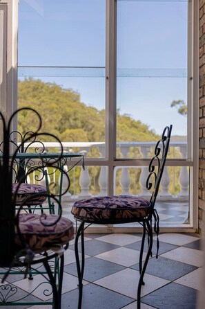 A balcony with a view of trees and a white balustrade. - Luxury Waterfront Retreat with Private Pool (Daleys Point)
