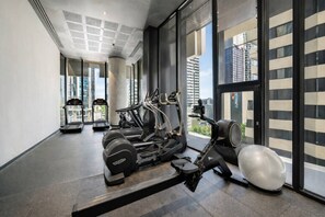 A gym with treadmills, elliptical machines, and free weights. - Designer 2BR · Heart of CBD · Pool + Free Trams (Melbourne)