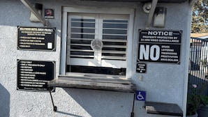 A motel office with a no smoking sign, guest policies, and a notice about 24-hour video surveillance. - HOLLYWOOD MOTEL (Los Angeles)