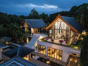 A modern two-story house with a glass facade, a wooden deck, and a small pool. - Marina luxury 6-bedroom seaview villa (Thalang)