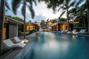 A modern resort with a swimming pool, lounge chairs, and tropical landscaping. - Marina luxury 6-bedroom seaview villa (Thalang)