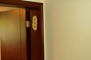 A wooden door with a sign indicating a room number.