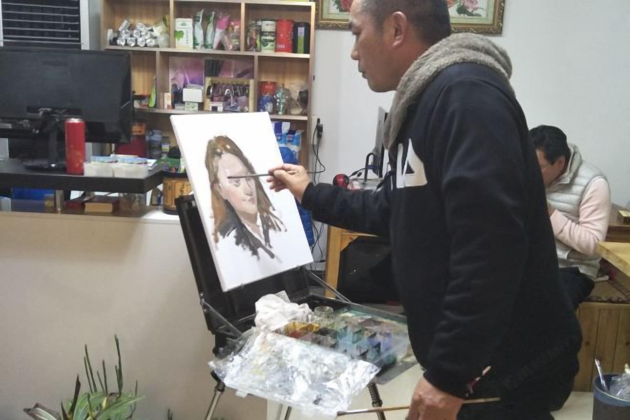 A person painting on a canvas in a room with shelves containing various items.