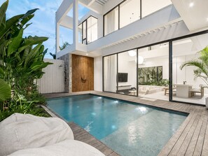 A modern house with a swimming pool, a wooden deck, and a glass-enclosed living area. - Casa Rio 3BR Enclosed Living & Pool (Keroboken Kelod)