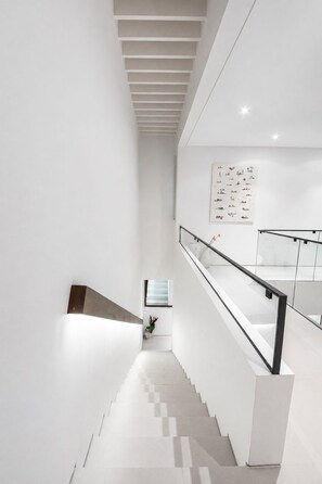 A modern staircase with a glass railing, white walls, and a ceiling with recessed lighting. - Casa Rio 3BR Enclosed Living & Pool (Keroboken Kelod)