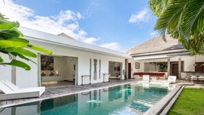 A modern house with a swimming pool, a glass-enclosed room, and a patio area. - Villa Saha Elegant 3BR Pool Oasis Seminyak (Seminyak)
