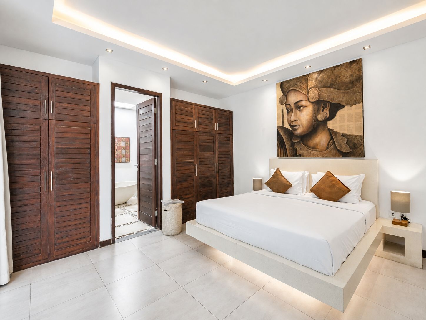 A modern bedroom with a large bed, wooden wardrobes, and a large painting on the wall.
