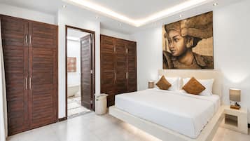 A modern bedroom with a large bed, wooden wardrobes, and a large painting on the wall.