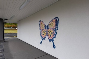 A wall with a butterfly mural.