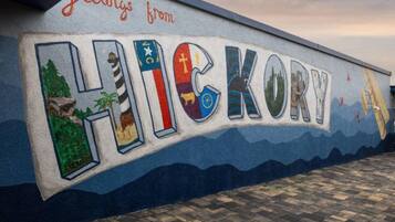 A wall with the word 'HICKORY' and a message 'Greetings from HICKORY' painted on it.